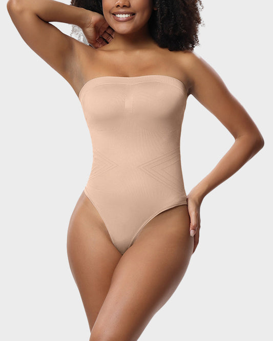 Woman wearing a beige strapless bodysuit on a plain background